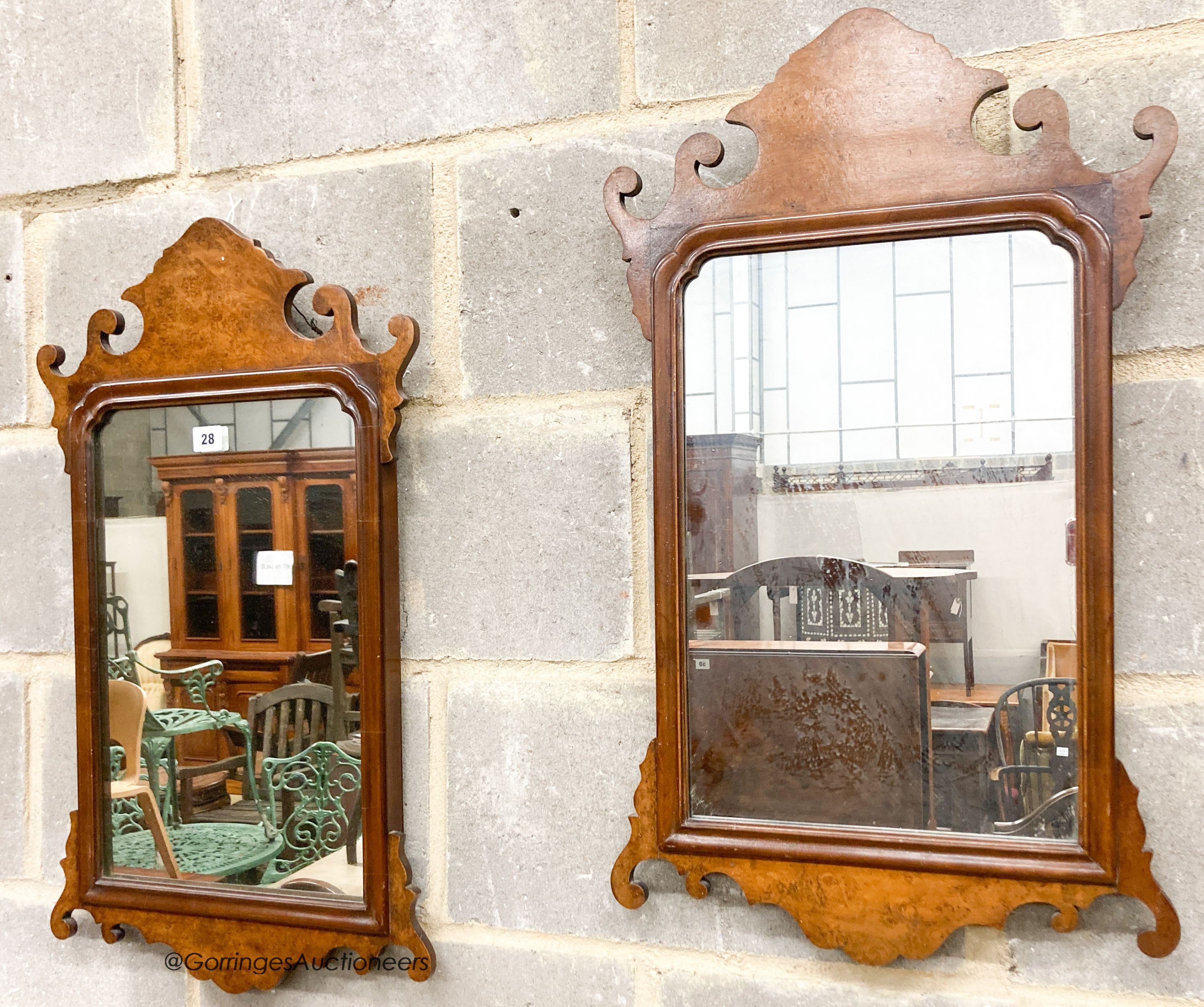 A pair of 18th century style walnut fret cut wall mirrors, width 42cm, height 70cm